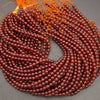 Glossy Hessonite Garnet gemstone beads featuring warm amber and deep red tones