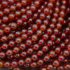 Natural Hessonite Garnet round gemstone bead strands in rich reddish-brown hues