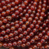 Natural Hessonite Garnet round gemstone bead strands in rich reddish-brown hues