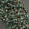 Heap of multicolored stones on a gray background
