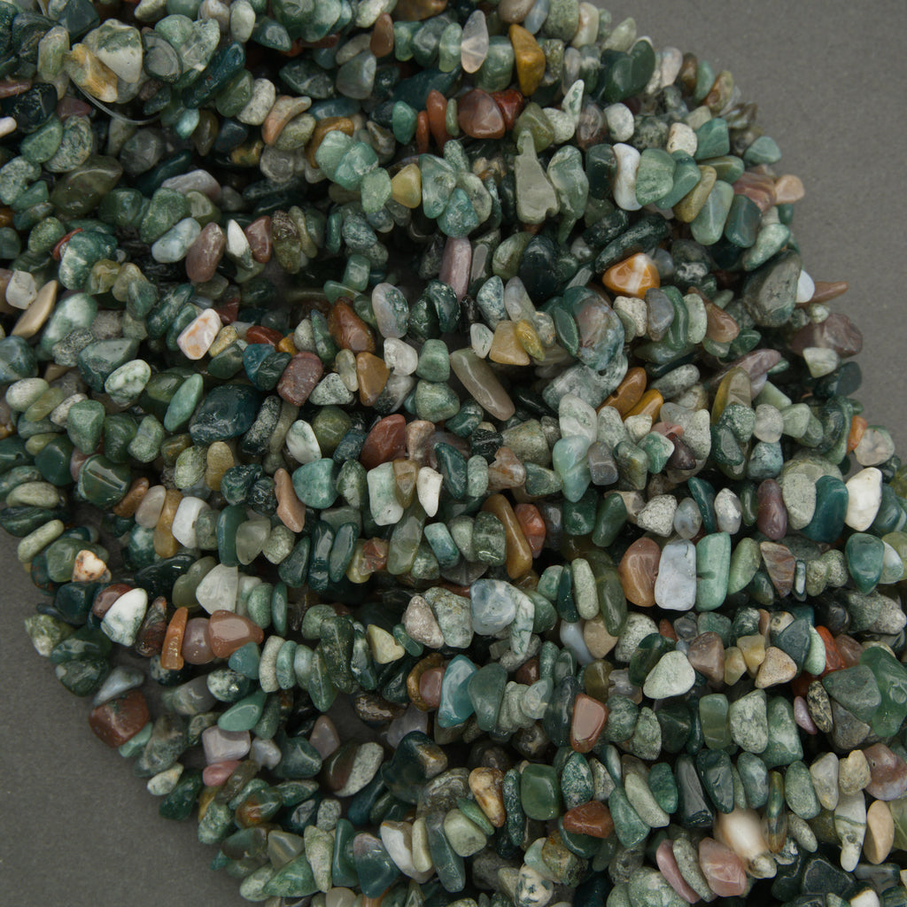 Heap of multicolored stones on a gray background