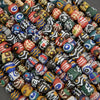 Assorted colorful beads with various patterns on a gray background