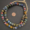 Colorful beaded necklace on a dark background with a penny for scale