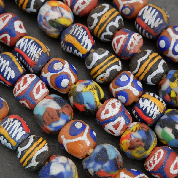Colorful painted stones with various patterns on a dark surface