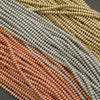 Close-up of woven fabric in brown, green, and beige on a dark background