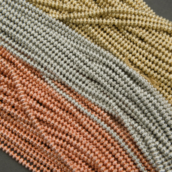 Close-up of woven fabric in brown, green, and beige on a dark background