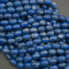 Close-up of blue oval beads on a gray background