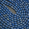 Close-up of blue beads on a dark background