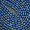 Close-up of blue beads on a dark background