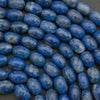 Close-up of blue oval beads on a dark background