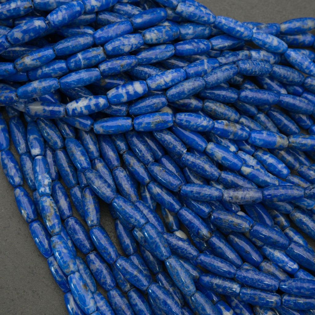 Close-up of blue cylindrical beads on a gray background