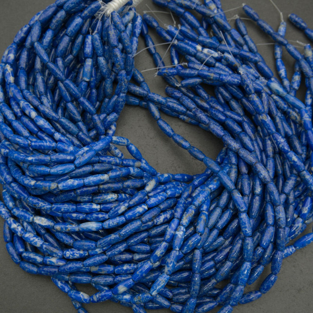 Coiled blue glass beads on a gray background