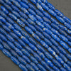Close-up of blue cylindrical beads on a dark background