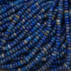 Natural lapis lazuli rondelle beads featuring vibrant royal blue tones, white calcite inclusions, and golden pyrite flecks.