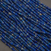 Close-up of blue lapis lazuli gemstone rondelle beads with natural mineral patterns and a soft matte finish.