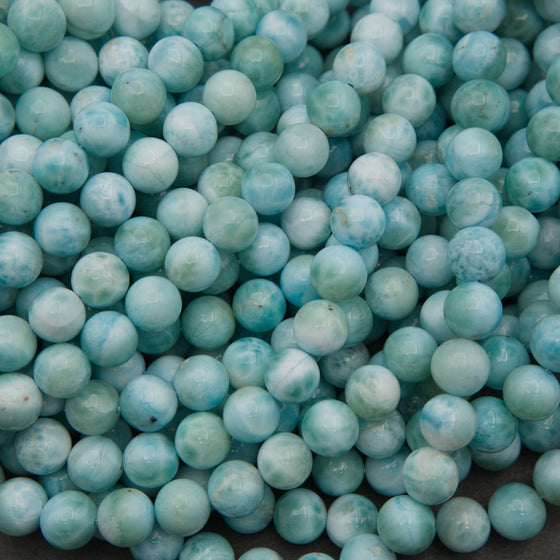 Smooth round larimar beads in turquoise blue and sea green with white cloudy patterns