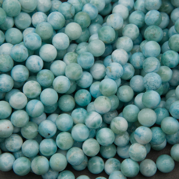 Smooth round larimar beads in turquoise blue and sea green with white cloudy patterns