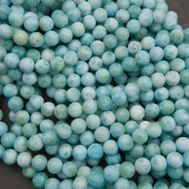 Strands of smooth round larimar beads in turquoise, sea green and white