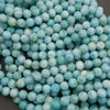Strands of smooth round larimar beads in turquoise, sea green and white