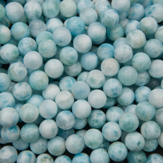 Smooth round larimar beads in pale sky blue and light aqua with white cloudy patterns