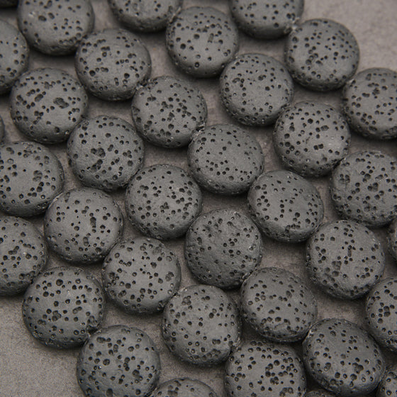 Black lava stone coin beads with a matte finish and naturally porous volcanic texture for jewelry making.