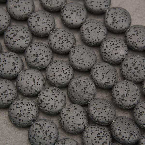 Black lava stone coin beads with a matte finish and naturally porous volcanic texture for jewelry making.