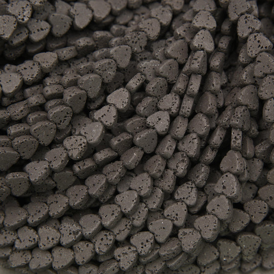 Black lava stone heart beads with a matte finish and naturally porous volcanic texture for jewelry making.