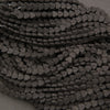 Strands of black volcanic lava stone heart-shaped beads with a textured charcoal-black finish.