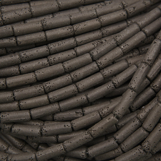 Natural black lava stone tube beads with a matte finish and porous volcanic texture for jewelry making.