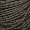 Natural black lava stone tube beads with a matte finish and porous volcanic texture for jewelry making.
