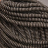 Close-up of black lava rock rondelle beads featuring flattened round shapes and distinctive volcanic pitting.
