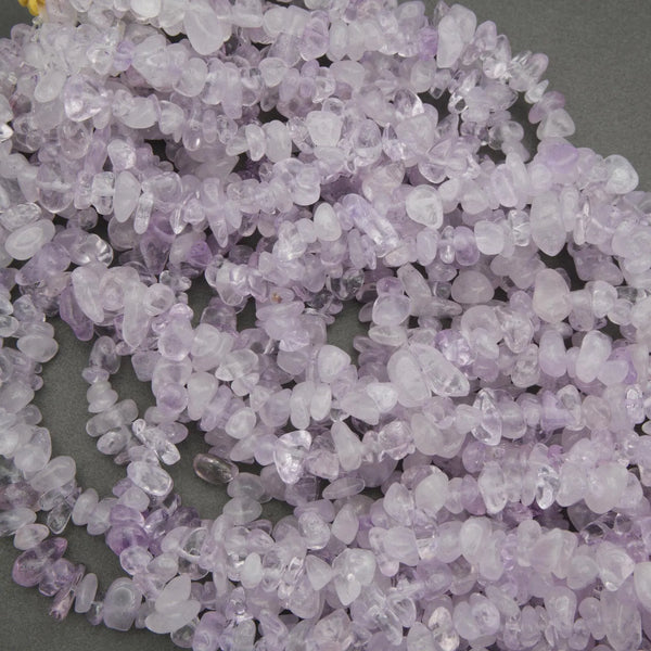 Close-up of a pile of small purple stones on a gray background