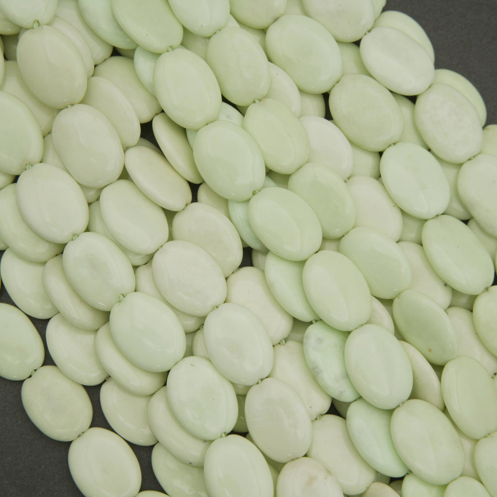 Close-up of light green beans on a dark background
