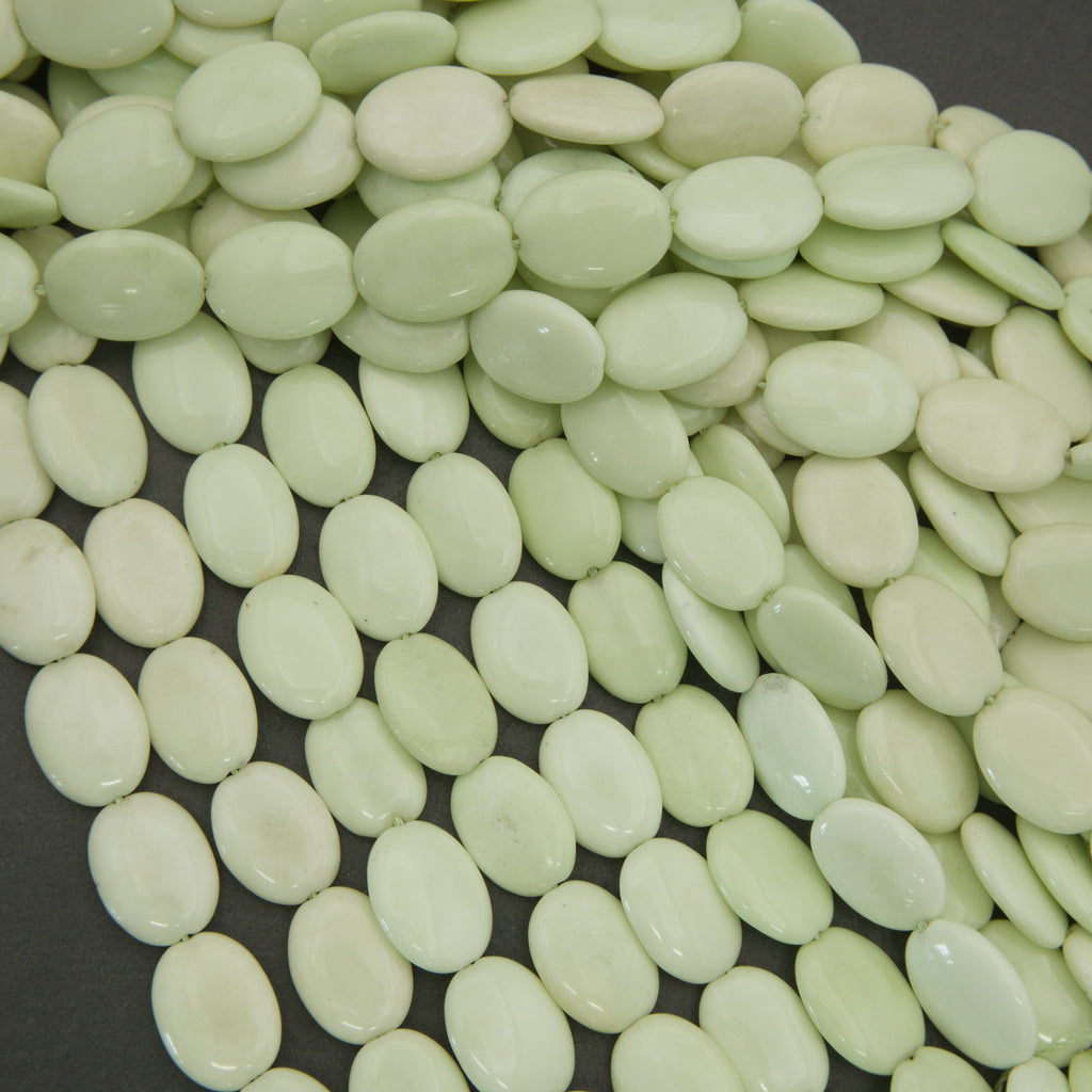 Close-up of light green oval-shaped objects on a dark background