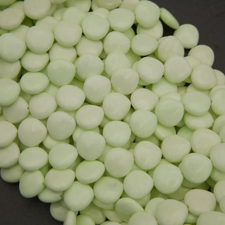 Close-up of light green beads on a dark background