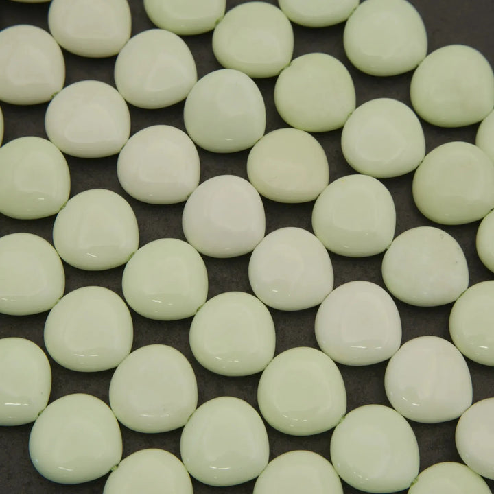 Close-up of light green beads on a dark background
