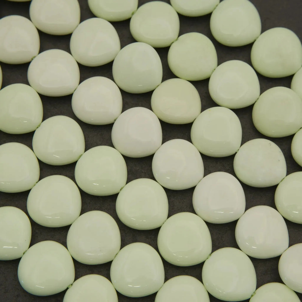 Close-up of light green beads on a dark background