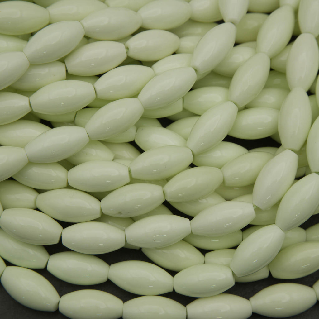 Close-up of light green oval beads on a black background