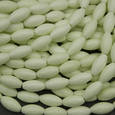Close-up of light green oval beads on a black background