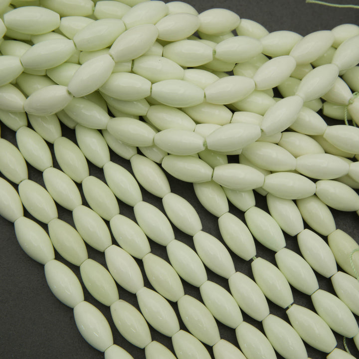 String of light green beads on a dark background
