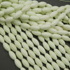 String of light green beads on a dark background