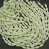 Neon green beads on a black background