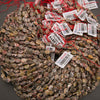 A bundle of faceted leopard skin jasper oval bead strands with Tejas Beads tags