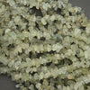 Close-up of small greenish crystals on a dark background