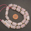 pink calcite beads with a penny for scale.