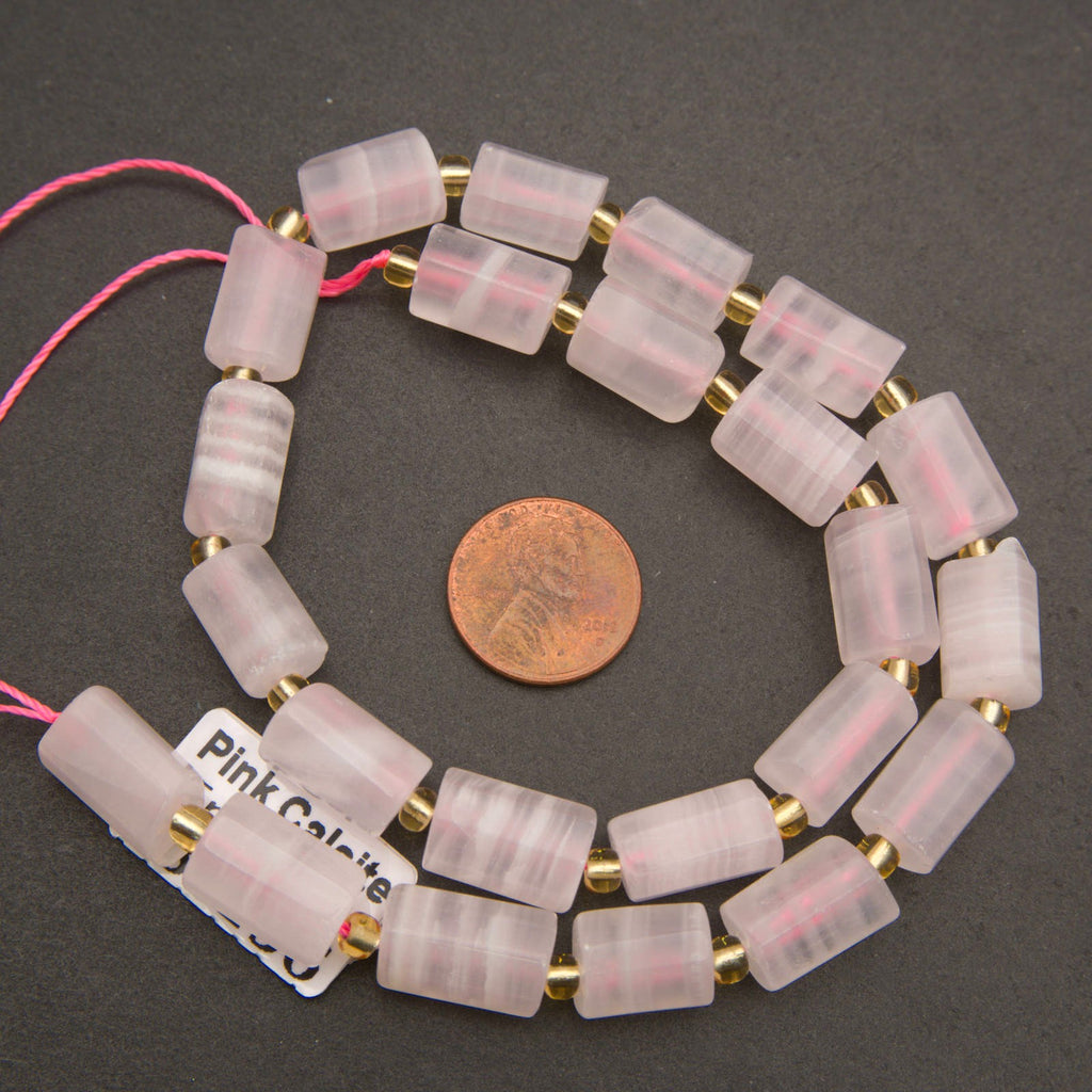 pink calcite beads with a penny for scale.