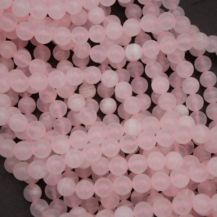 Close-up of pink beads on a dark surface