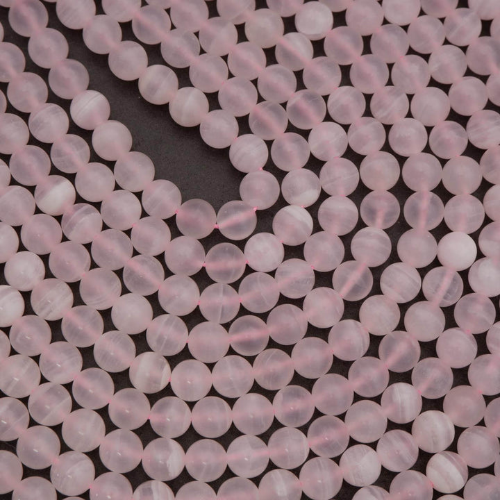 Close-up of pink beads on a dark background