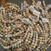 Close-up of assorted beads with visible labels on a gray background
