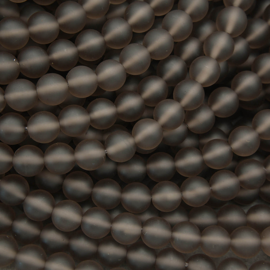 Close-up of dark gray beads arranged in a pattern
